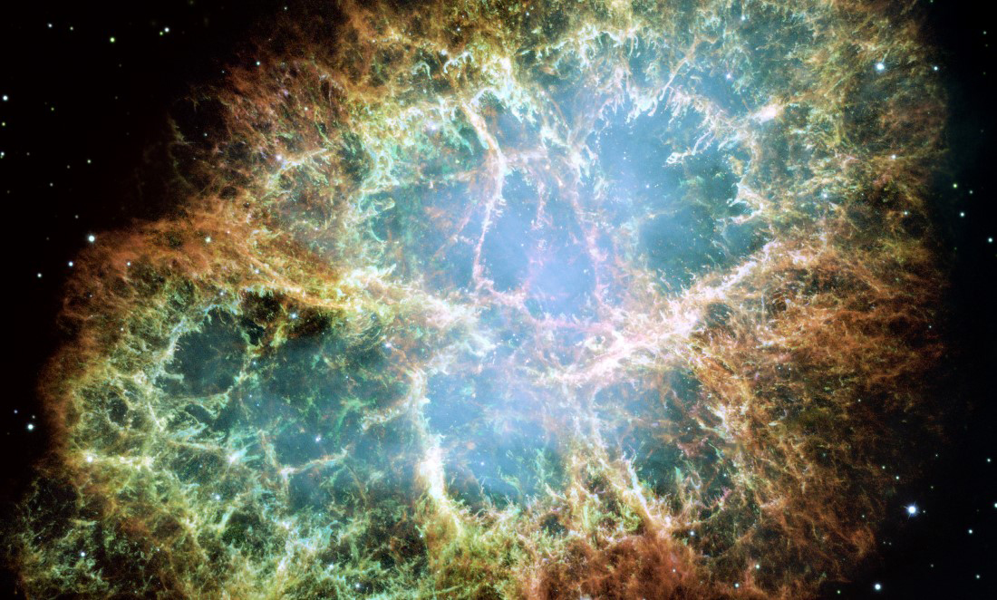 NASA image of the Crab Nebula, showing a yellow and green gaseous cloud