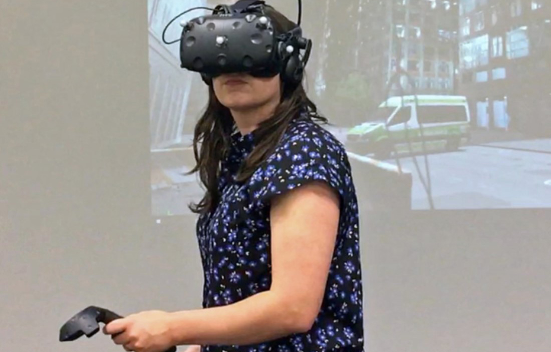 WOman wearing a virtual reality headset and testing controls