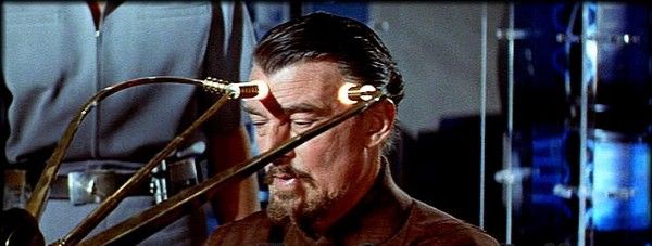 Movie still from 1956 showing a man with three electrodes attached to his forhead (Forbidden Planet)