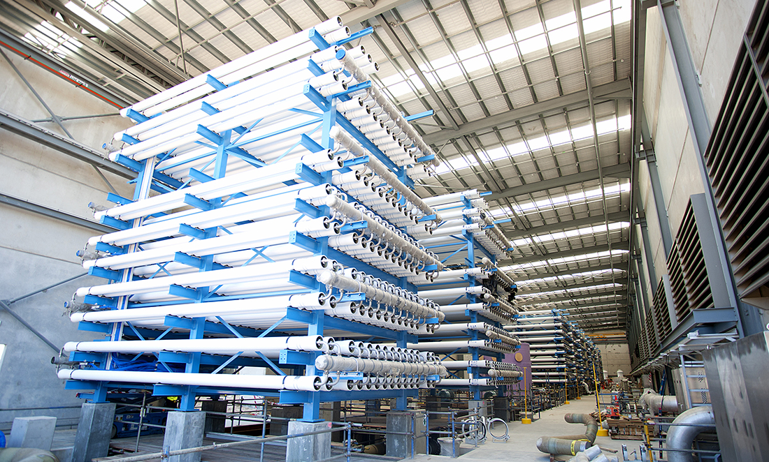 Large factory with tall silver structure which is a reverse osmosis unit
