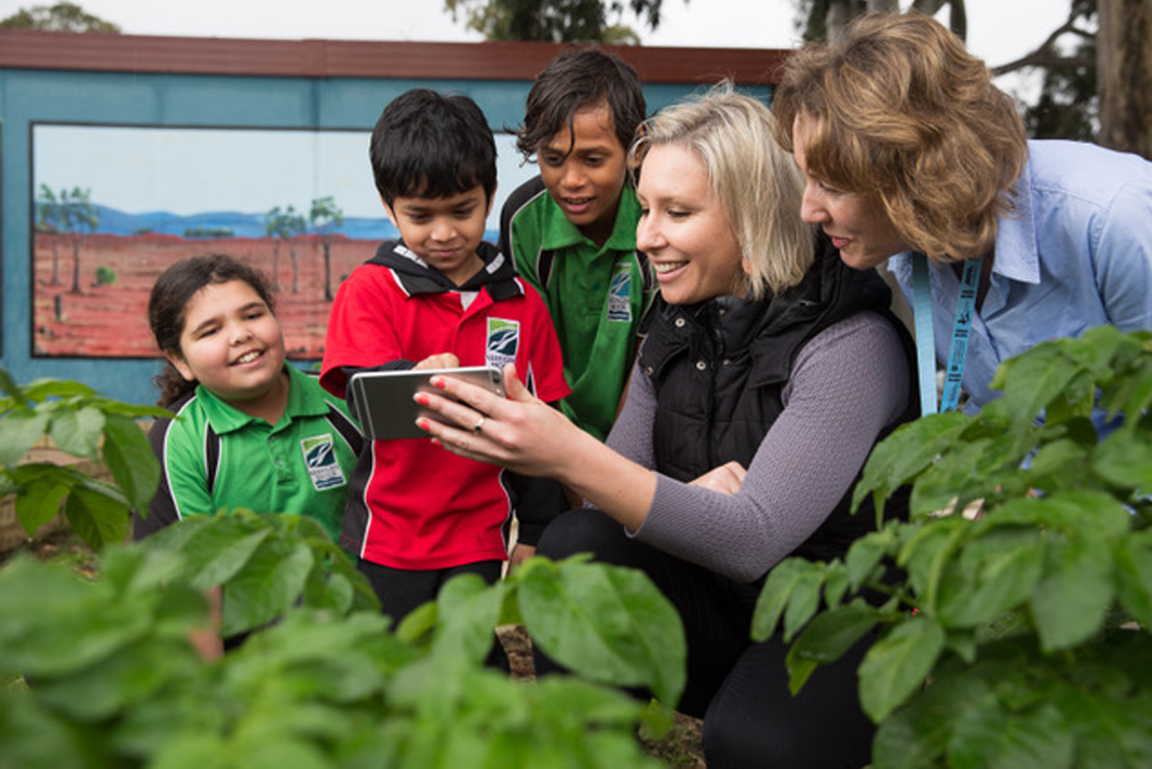 Dr Vanessa Rauland uses an tablet to teach young children about their environment