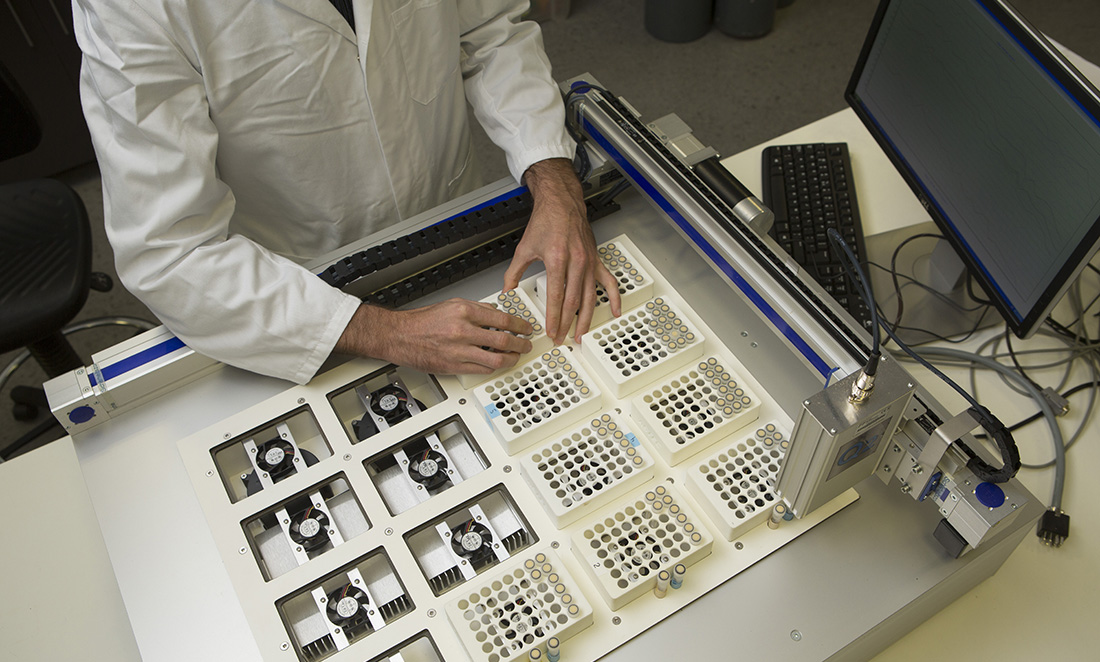 Looking down at a scientist working with a tray of samples