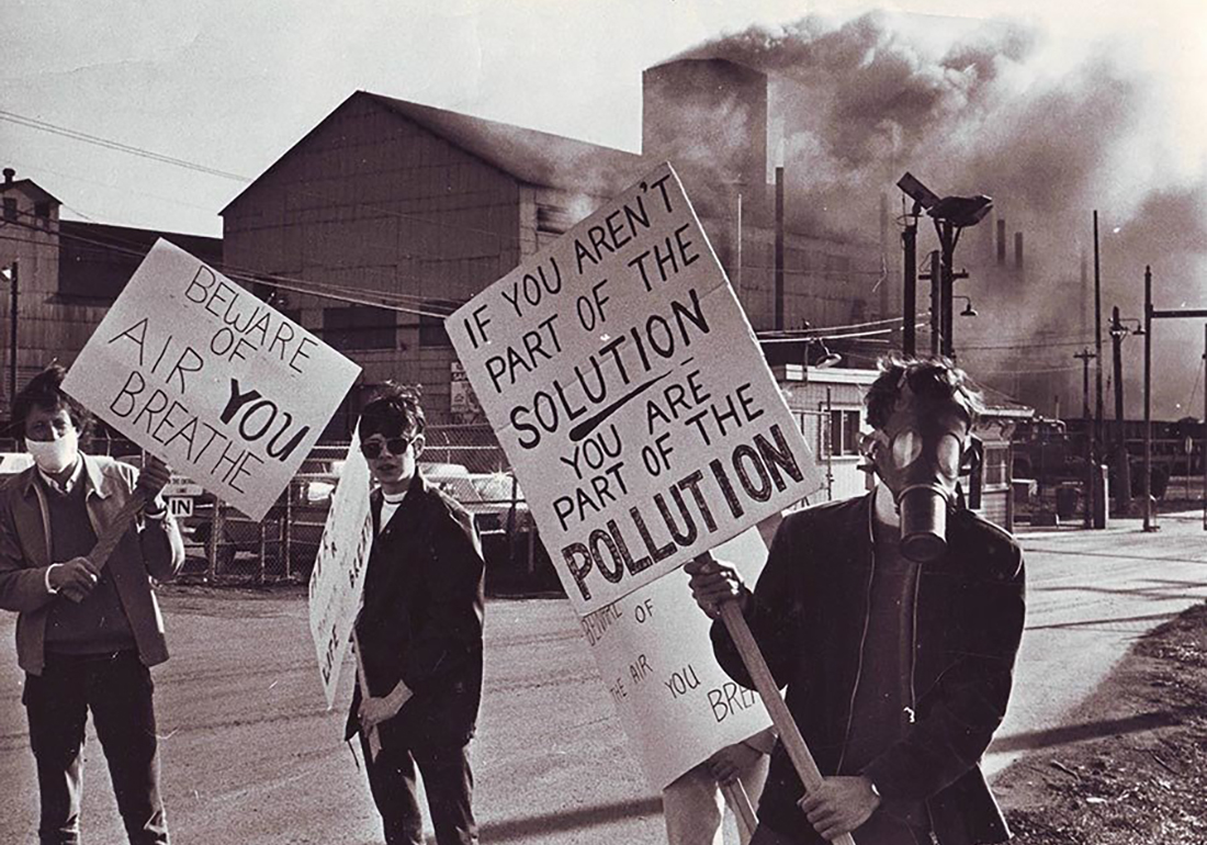 Climate protesters at the first Earth Day in 1970, wearing gas marks. One holds a sign that reads: 'If you arent part of the solution, you are part of the pollution'.