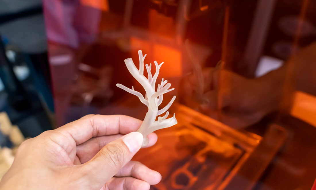 Hand with object in shape of medically accurate human blood vessel printed on 3D printer
