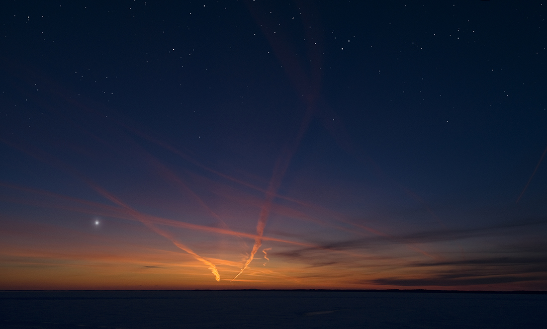 Sunset over the ocean, with venus visible on the horizon