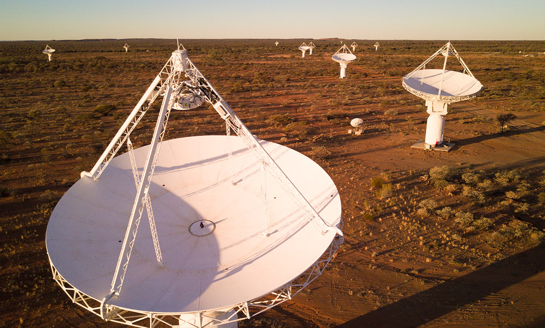 Large white dishes with triangular antennas built across the WA landscape as part of the Square Kilometre Array Pathfinder