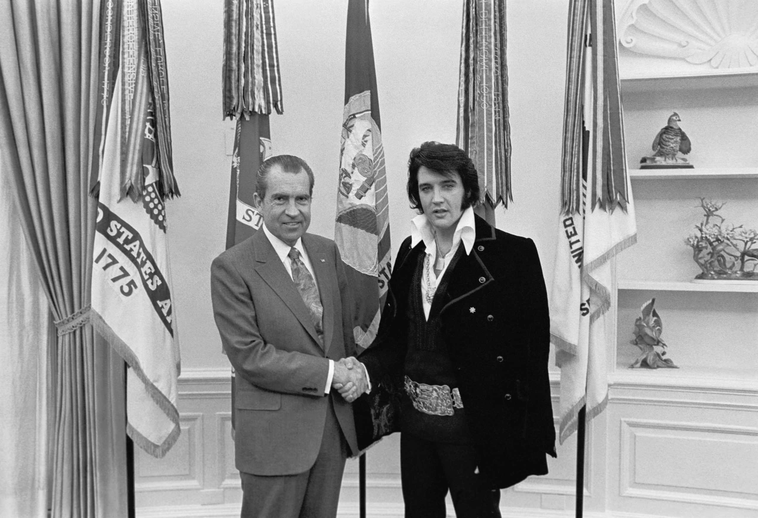 Richard M. Nixon shakes hands with Elvis Presley at the White House