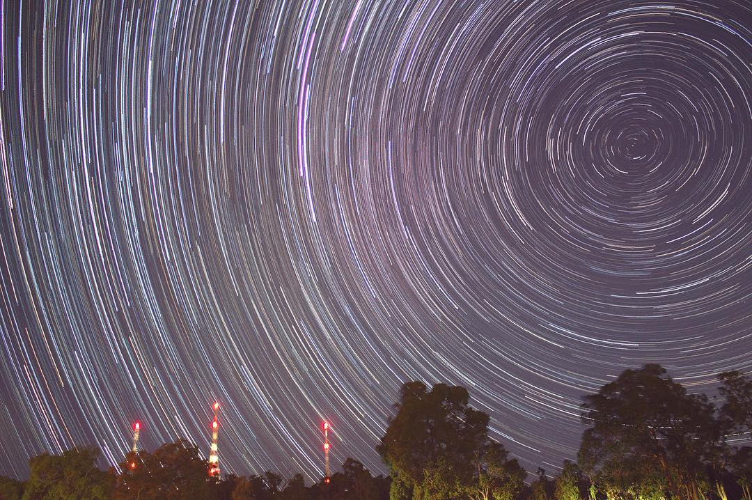 Star trails over an outdoor landscape