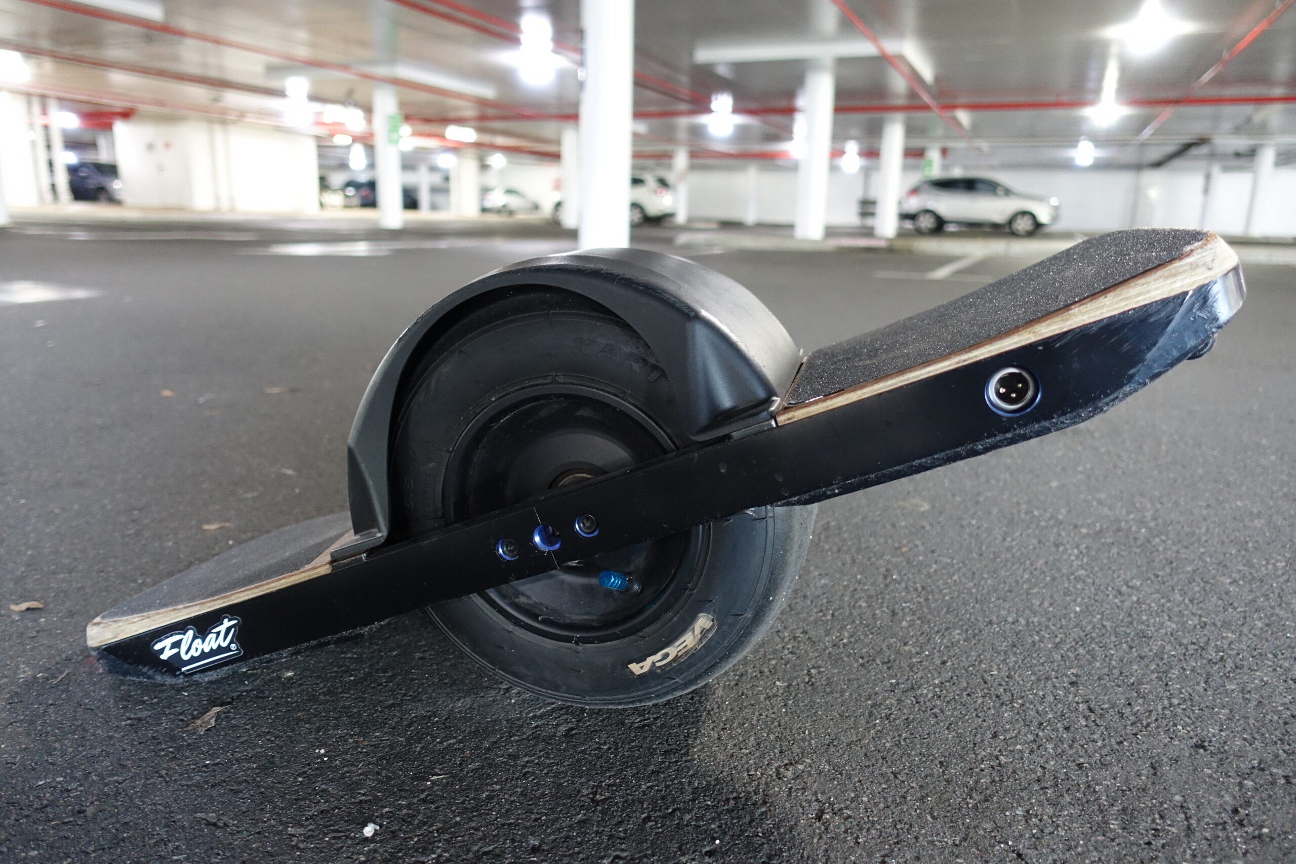 A close up of the Onewheel - a skateboard-esque vehicle with a single large wheel in the middle of the board.