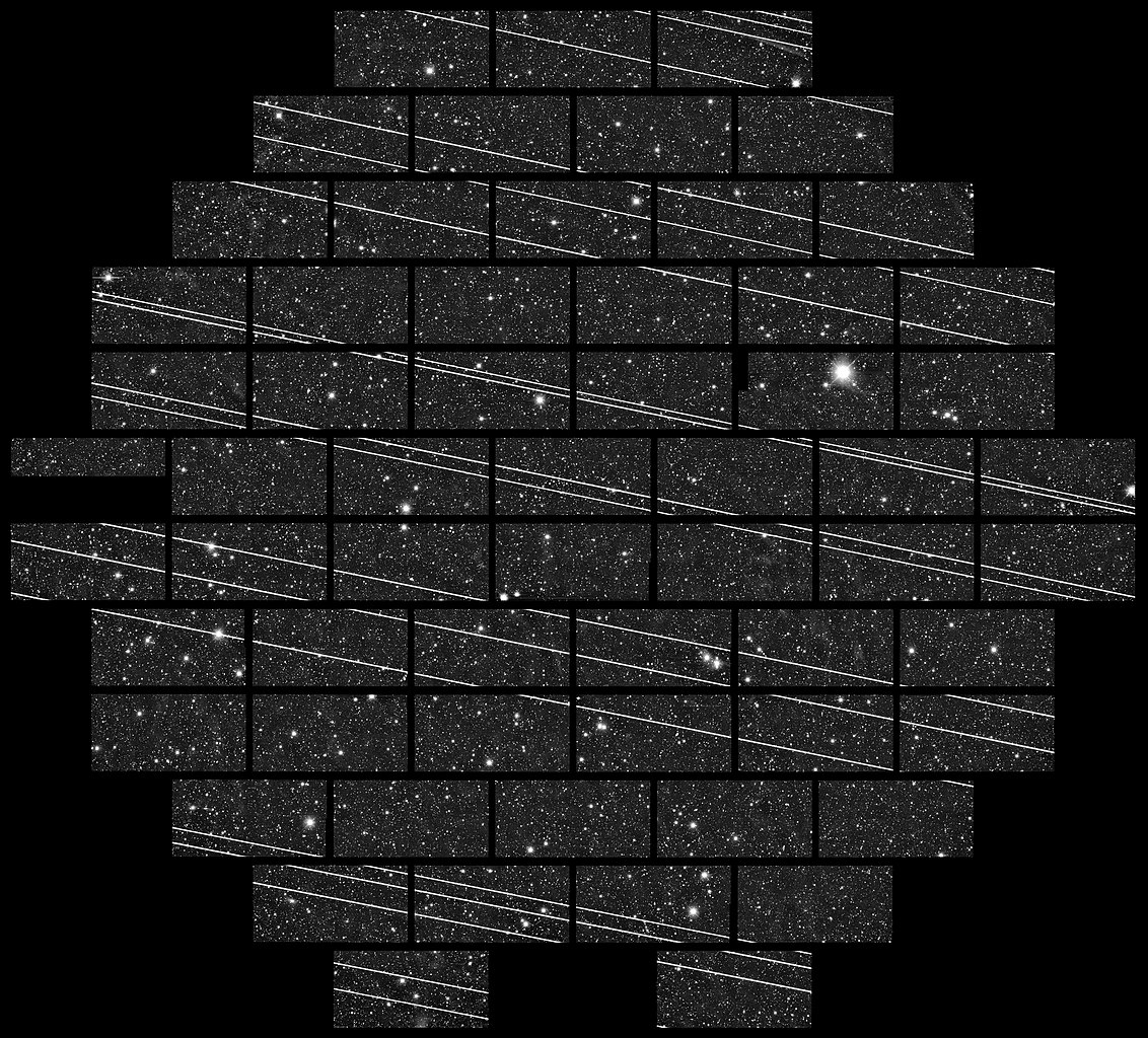 Starlink satellites leave streaks across a photo of the night sky.