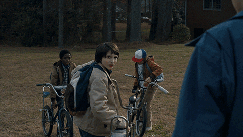 A gif showing the kids of 'Stranger Things' getting ready to ride their bikes