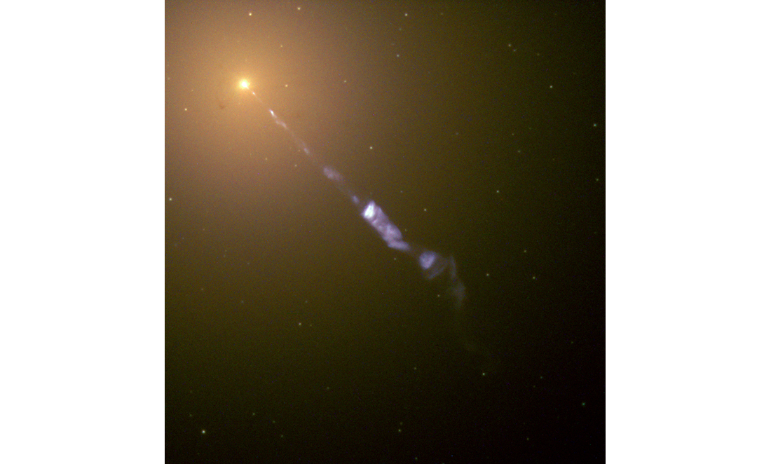 A jet of matter and energy from the galaxy Messier 87 looks like a blue streak in space from a bright orange source