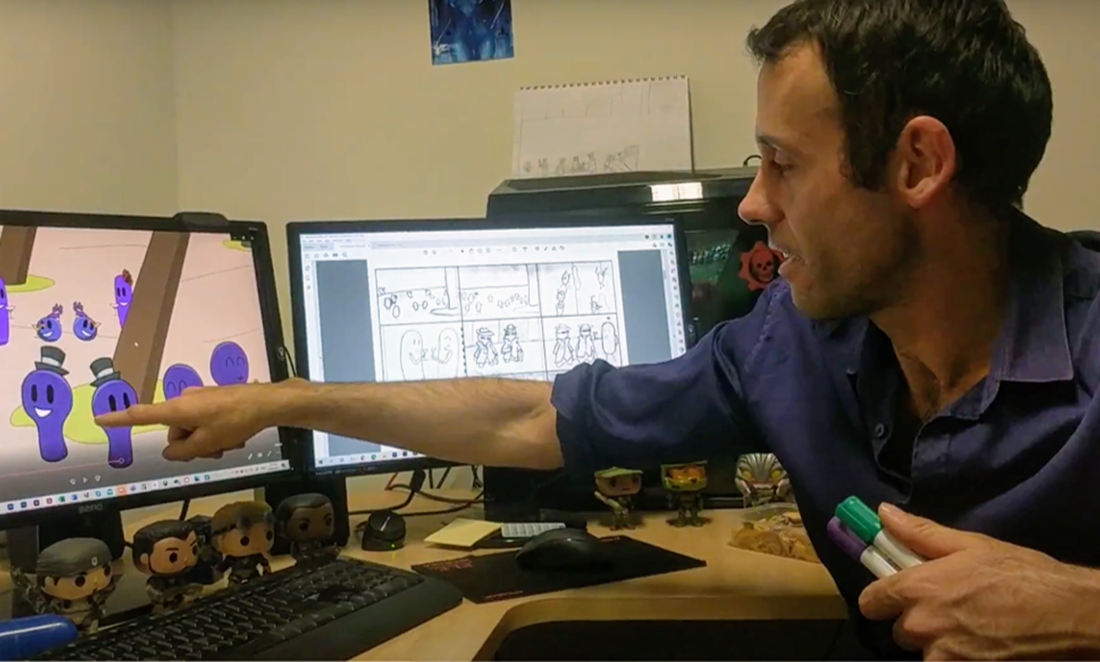 Aaron Welch, Founder and Director of Red Bird Creative, points to a computer screen, showing one of MicroToons animations he has been working on