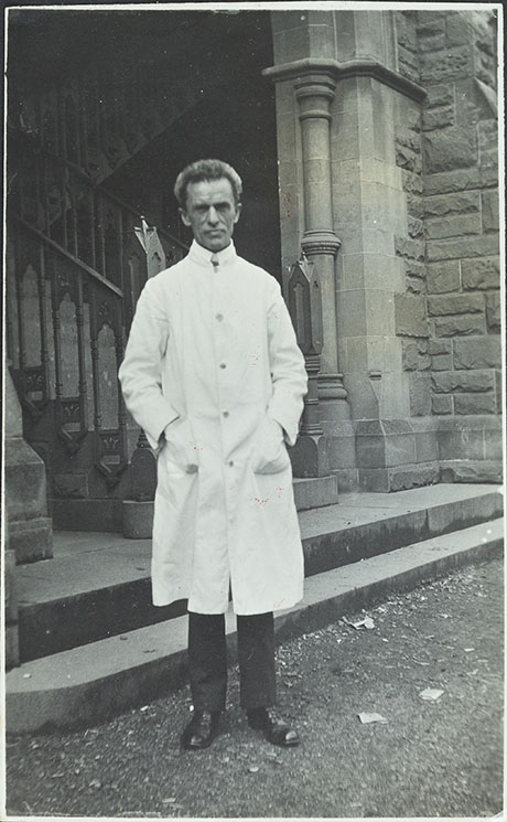 Black and white photo of Professor R. J. Berry standing outside a brick building