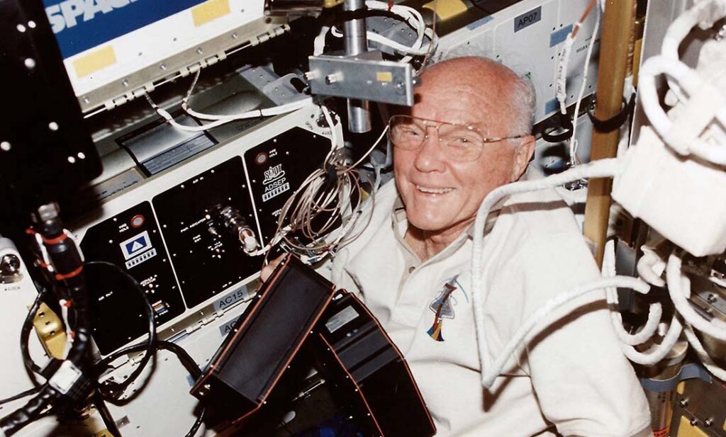 American astronaut John Glenn smile at the camera aboard the space shuttle Discovery in 1998.