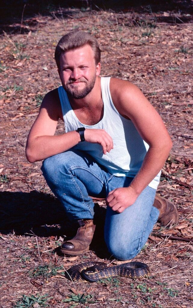 Caption Brad with a tiger snake 
Credit Supplied Brad Maryan